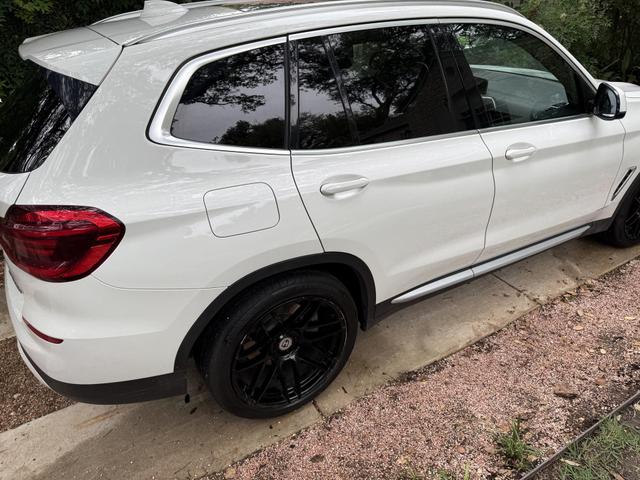 White BMW X3 SUV after exterior detail, showing polished paint and freshly cleaned black wheels